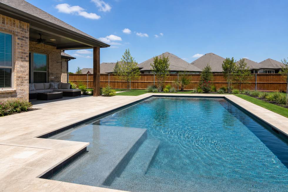Haslet family pool with shallow steps and patio